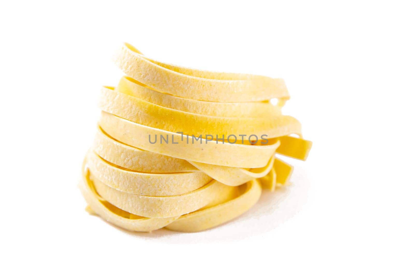 Italian pasta fettuccine nest isolated on white background.