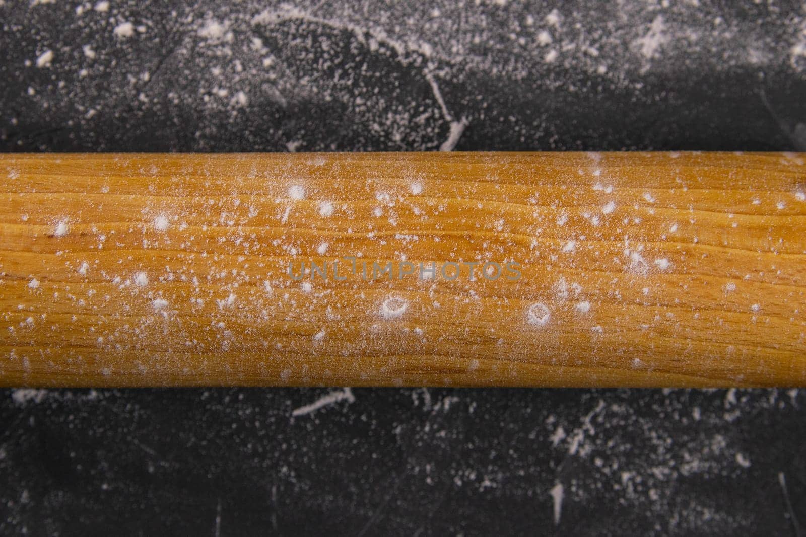 Baking desk with flour and rolling pin, top view.