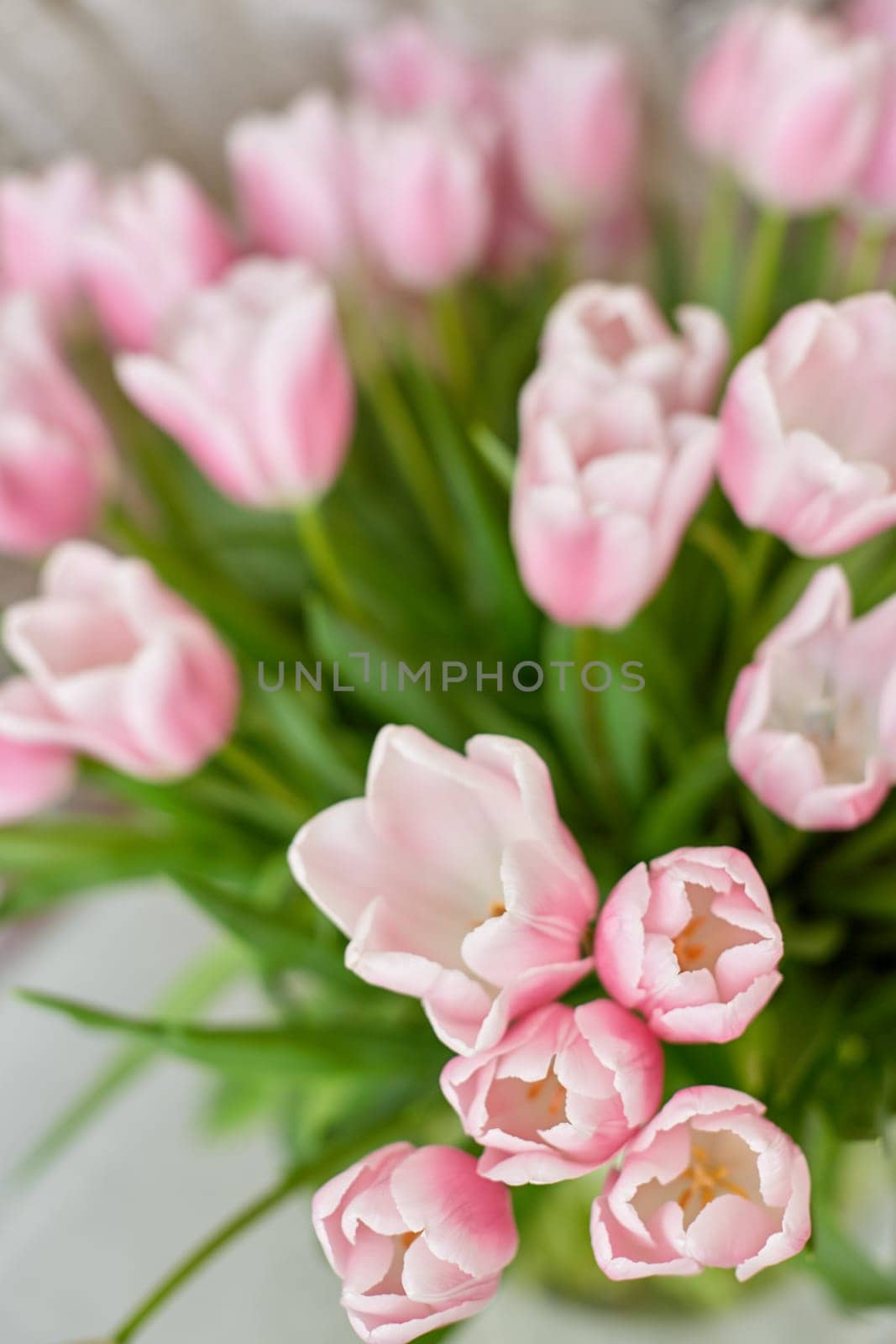 Decor and a vase with pink tulips on a table. Selective focus.