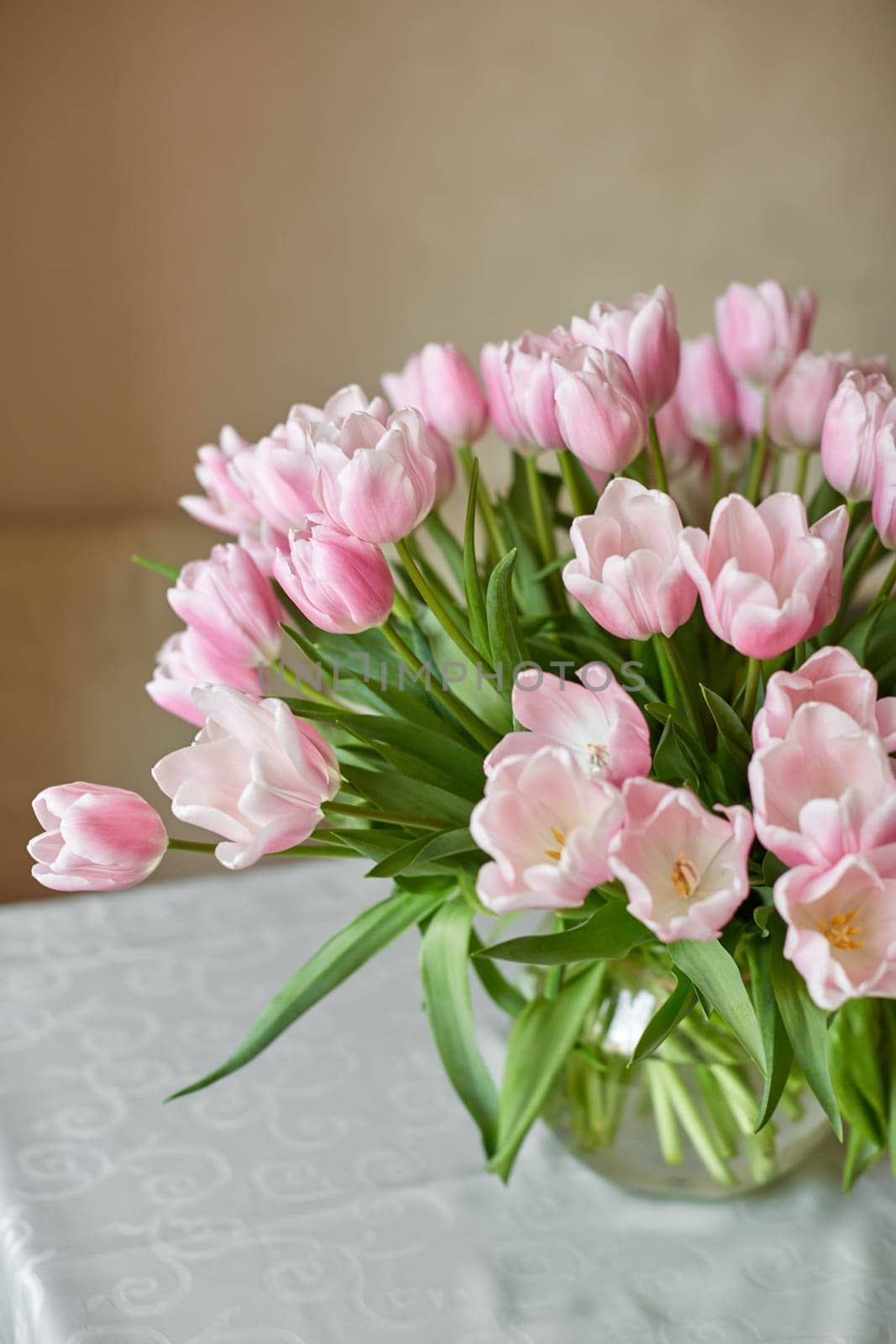 Decor and a vase with pink tulips on a table. Selective focus.