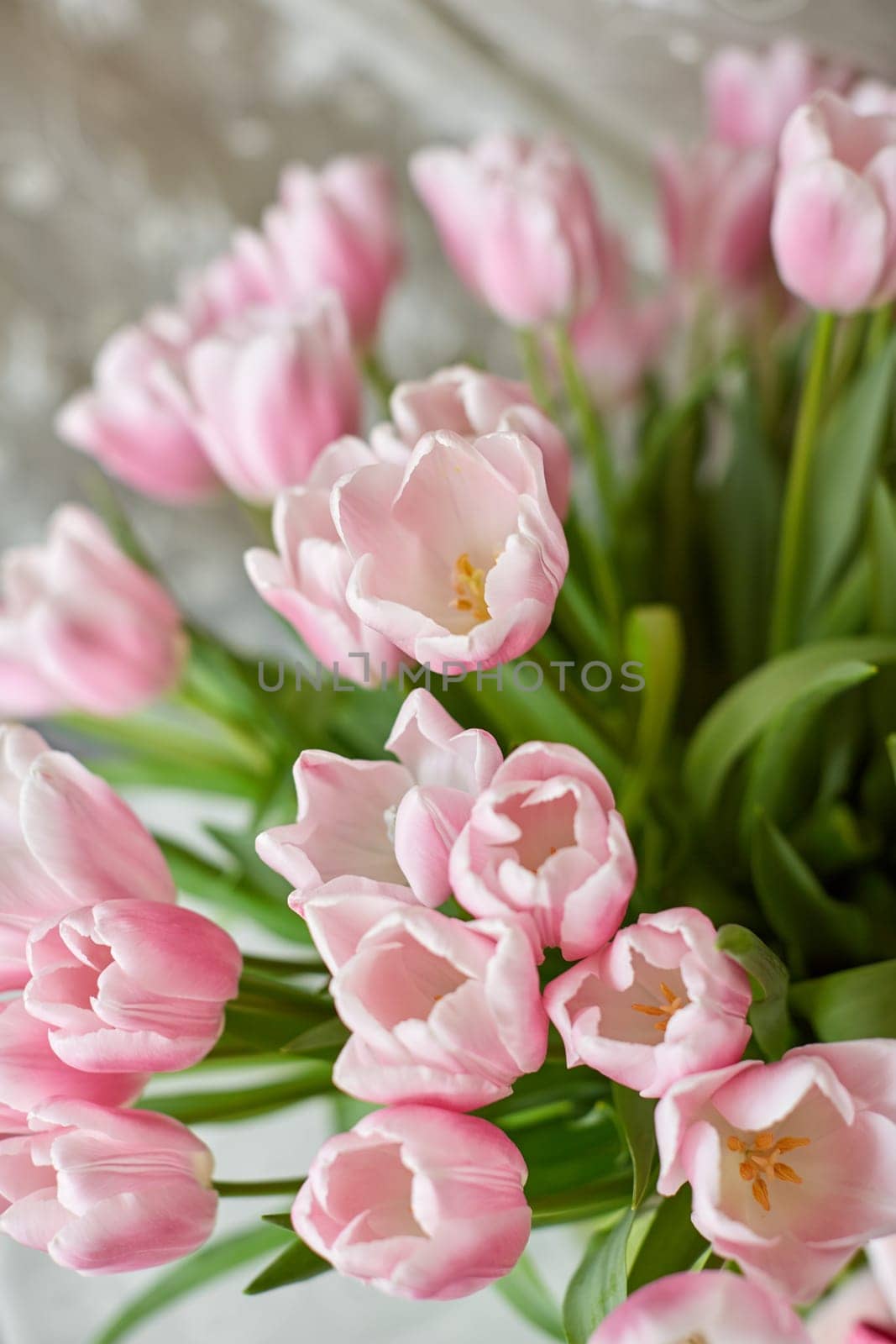 Decor and a vase with pink tulips on a table. Selective focus.
