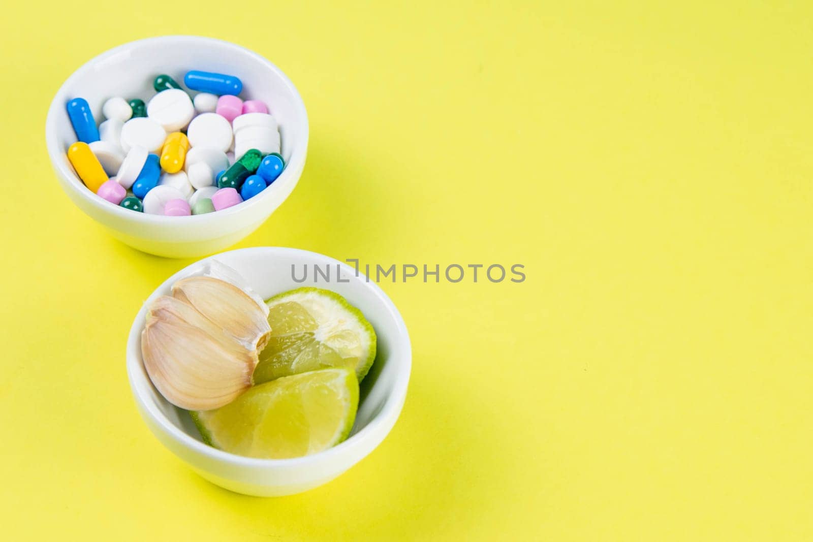 Lime and ginger against multi-colored tablets. The concept of choosing a healthy diet versus taking medication. Top views with clear space.