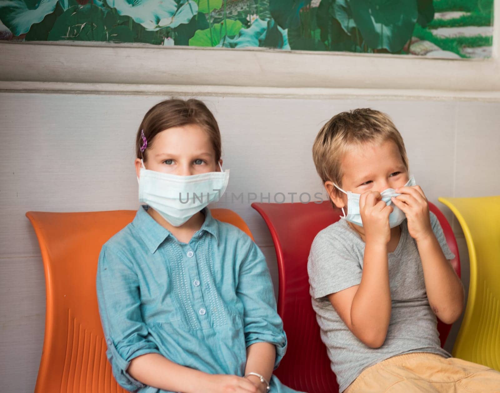 Kids wearing facial disposable mask to avoid viral infection. Virus protection