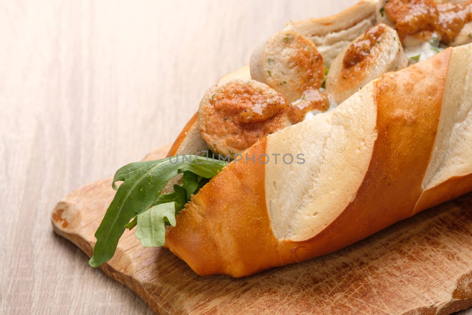 Lye roll with fried veal sausage, angula and sweet mustard