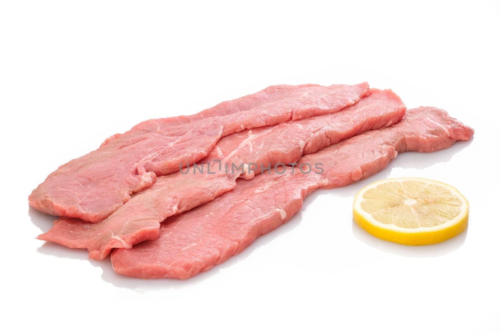 Three slices veal cutlet and lemon white isolated
