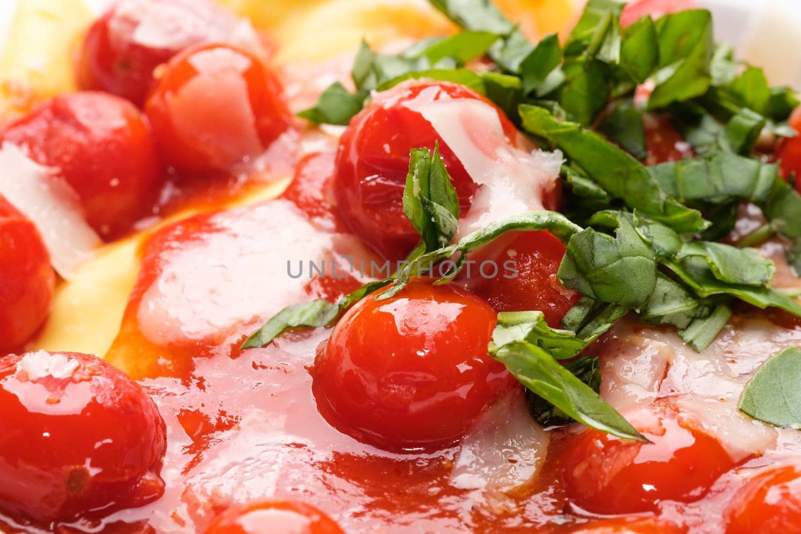 Red cherry tomato sauce with basil as close-up