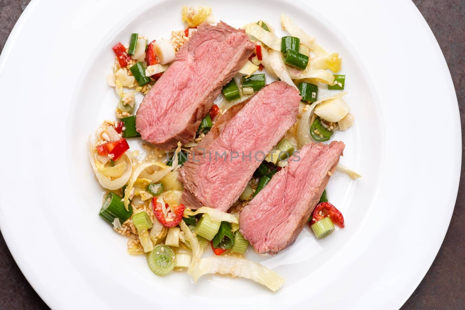 Duck breast sous vide and roasted on rice chili and spring oinions