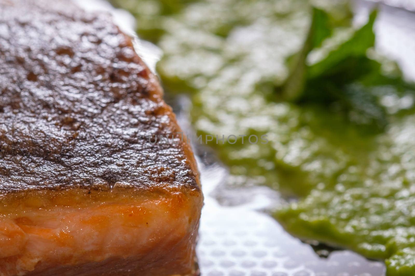 Salmon fish roasted with mashed peas as close-up