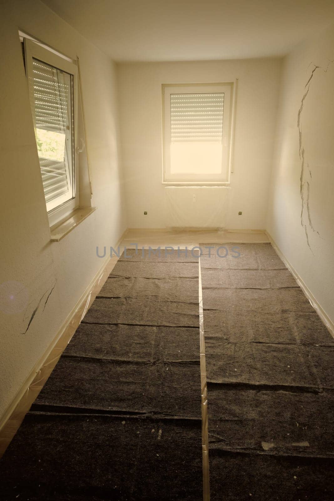 Room renovation with cracks in the wall in vertical format