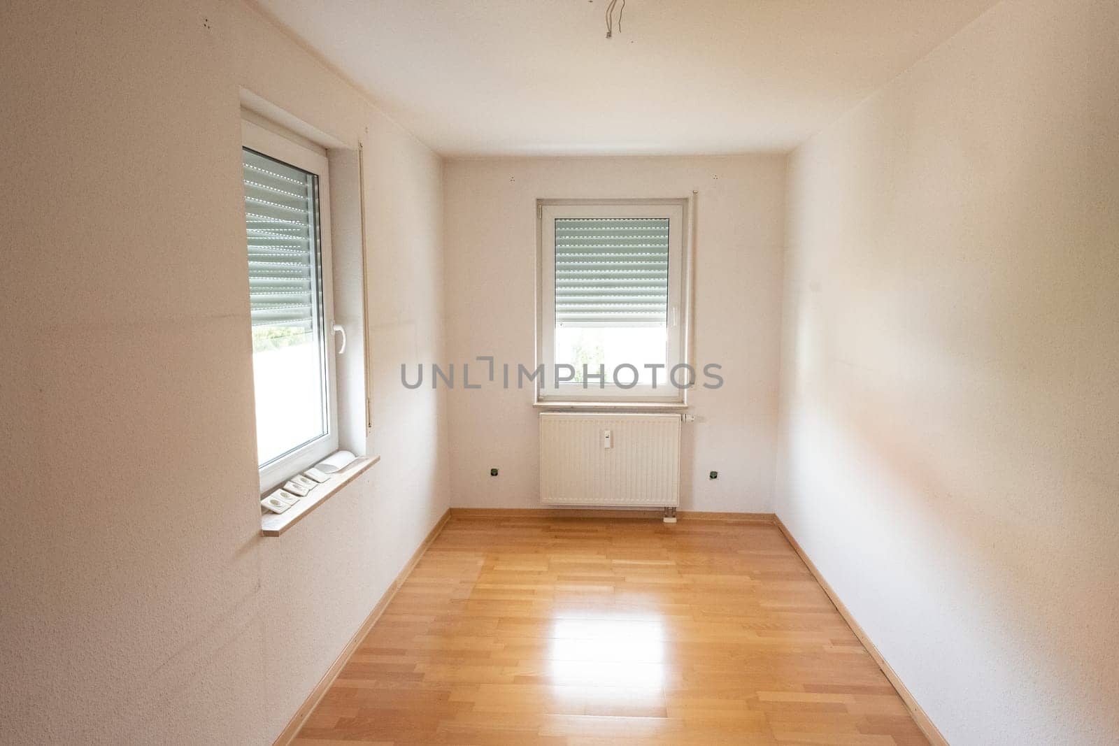 Empty room with window and parquet in back lit