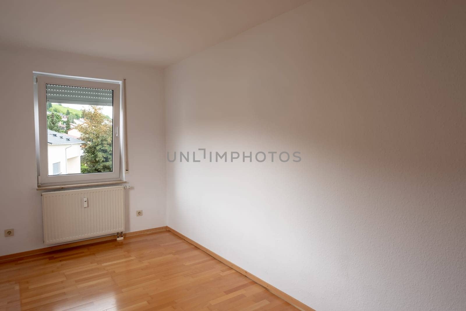 Empty renovated room with wooden parquet flooring