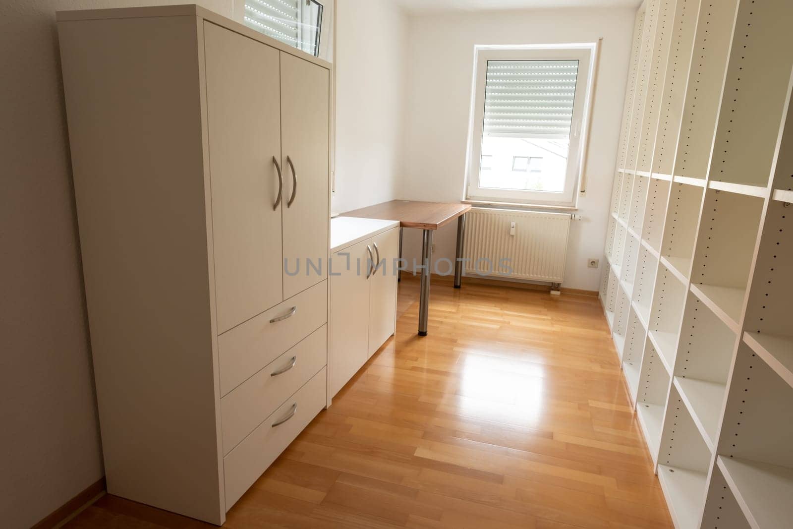 Office room with white rack cupboard and desk