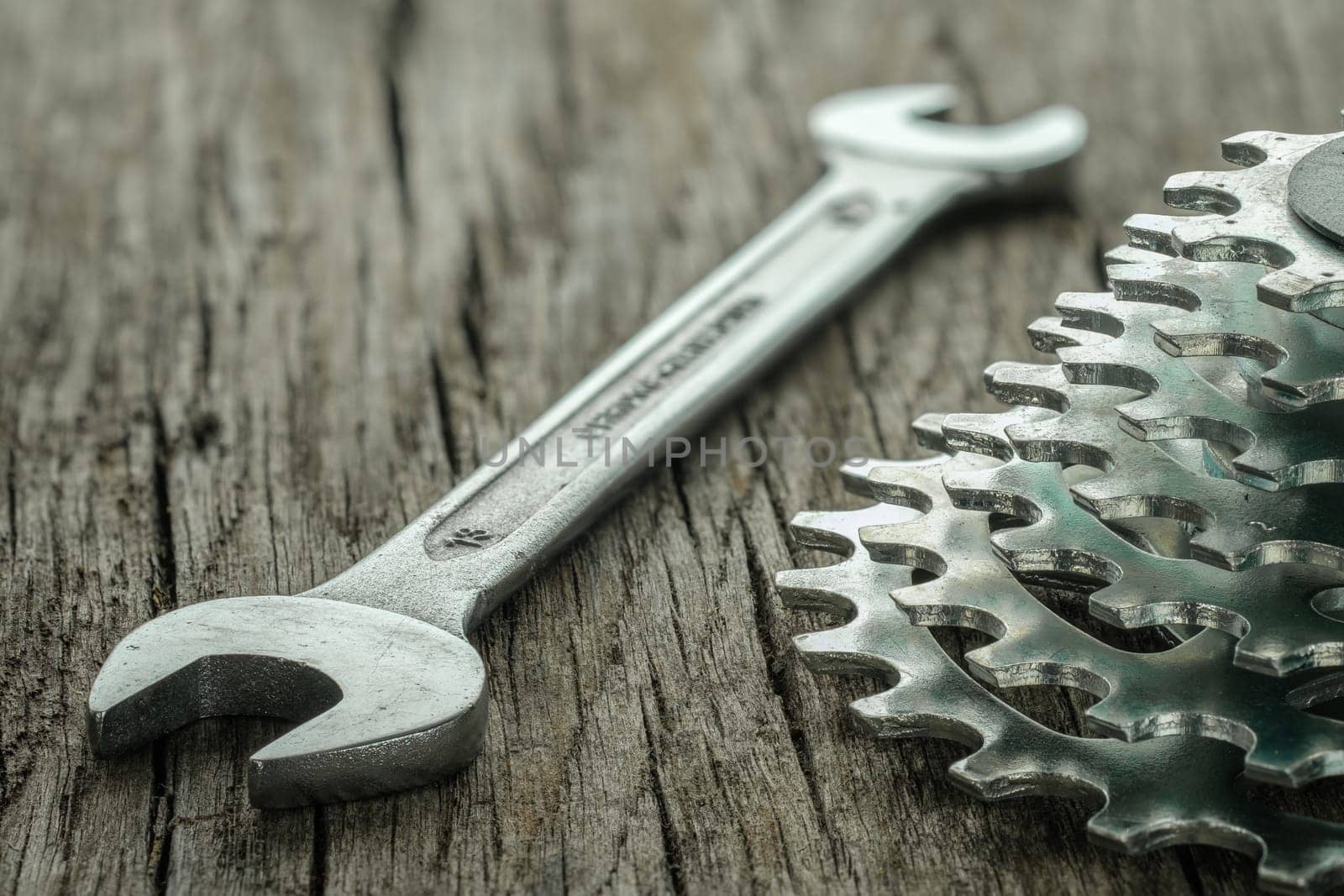 Wrench and sprocket for biycicle on wooden board