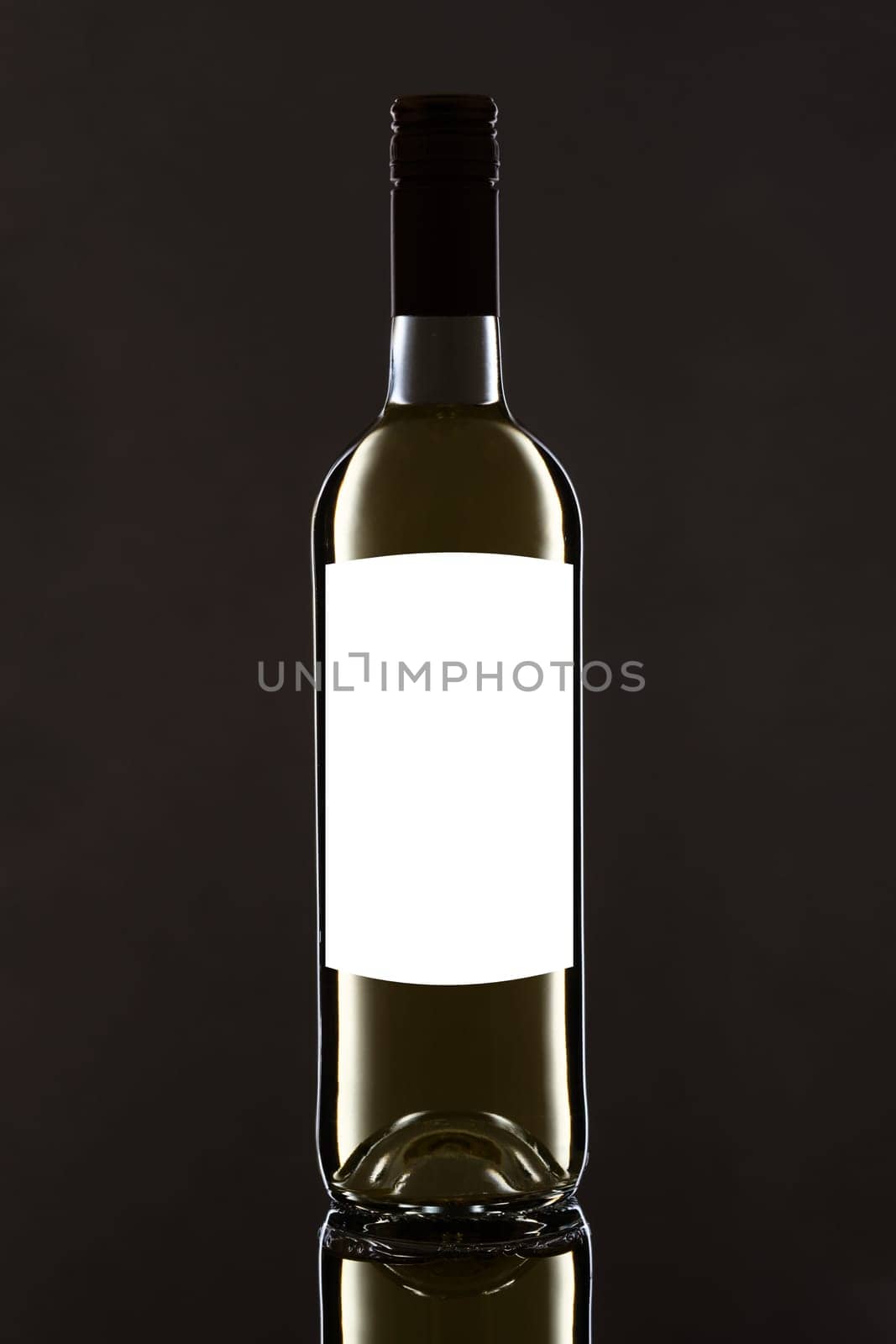 White wine bottle on black with label blank for text