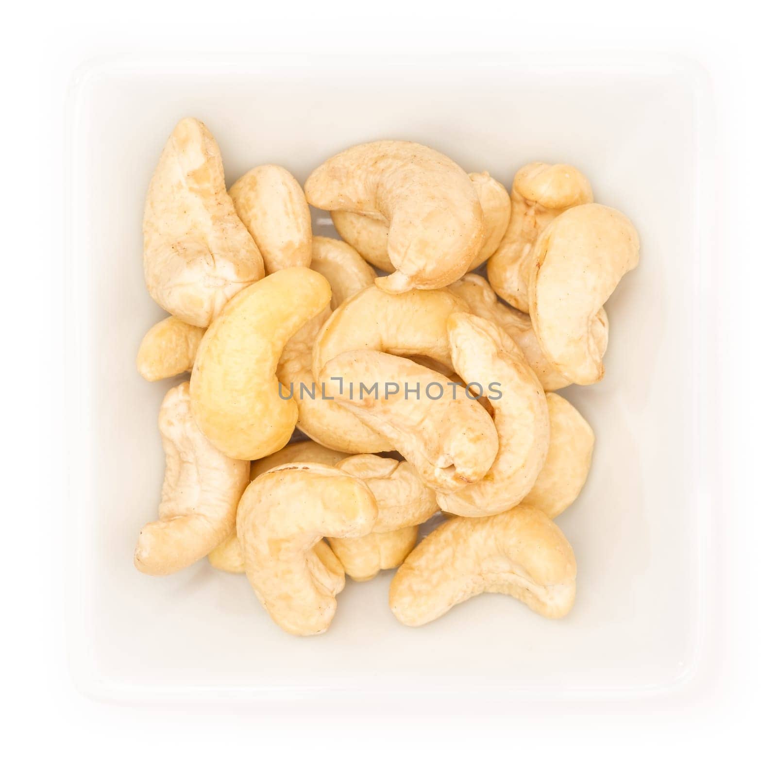 Cashew nut in a white square bowl in top view