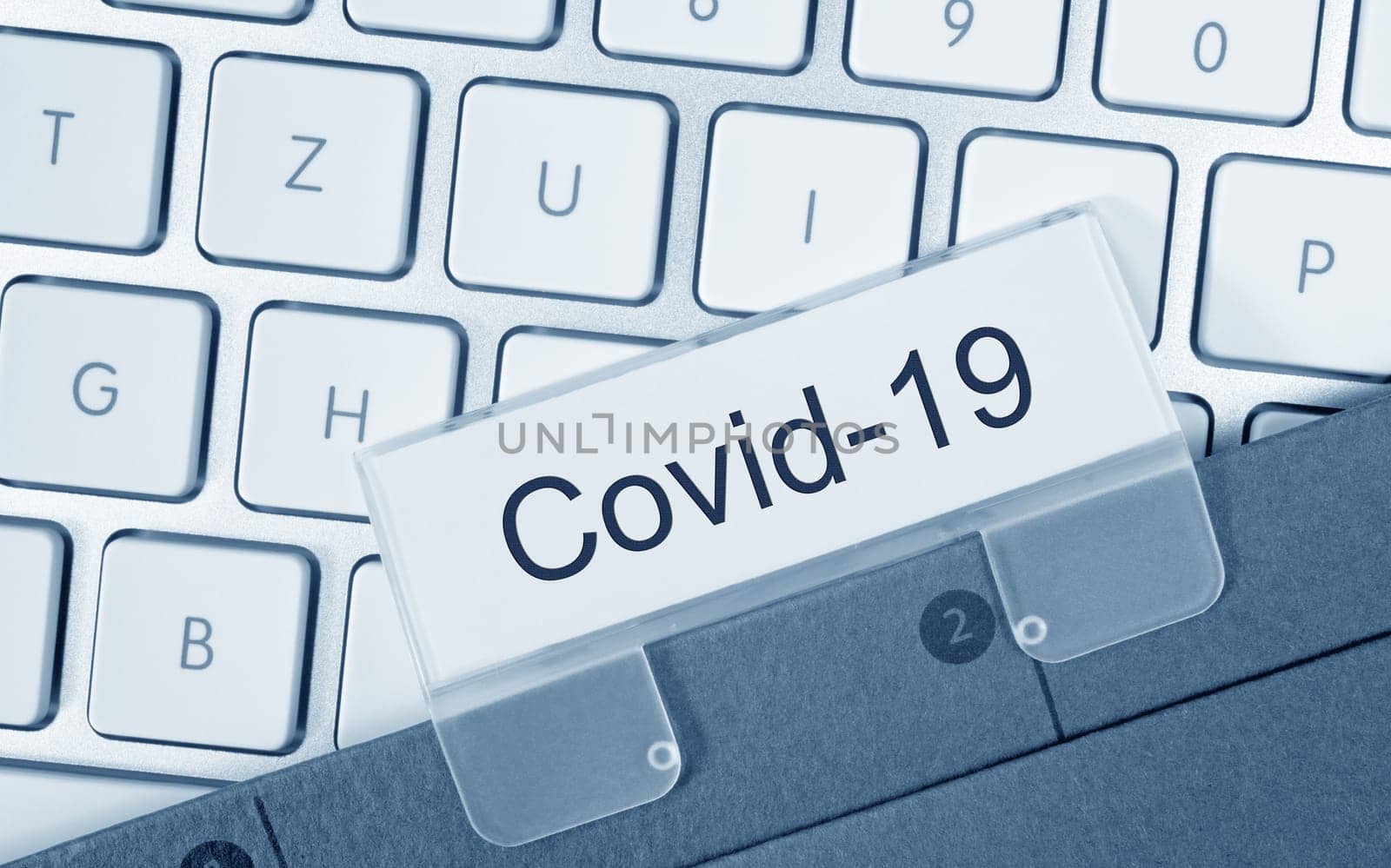 Covid-19 binder on computer keyboard in the office