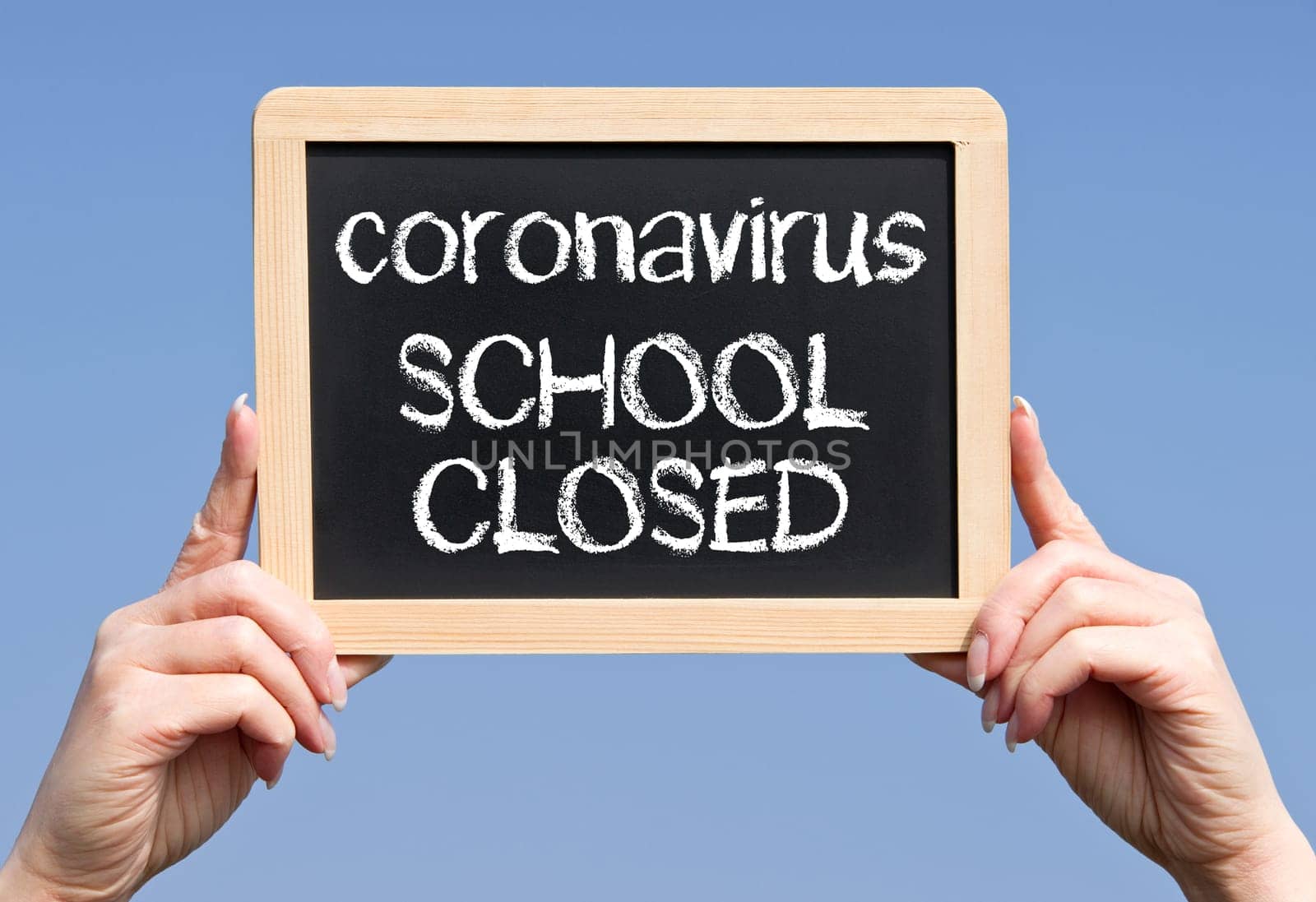 Coronavirus, school closed, female hands with chalkboard