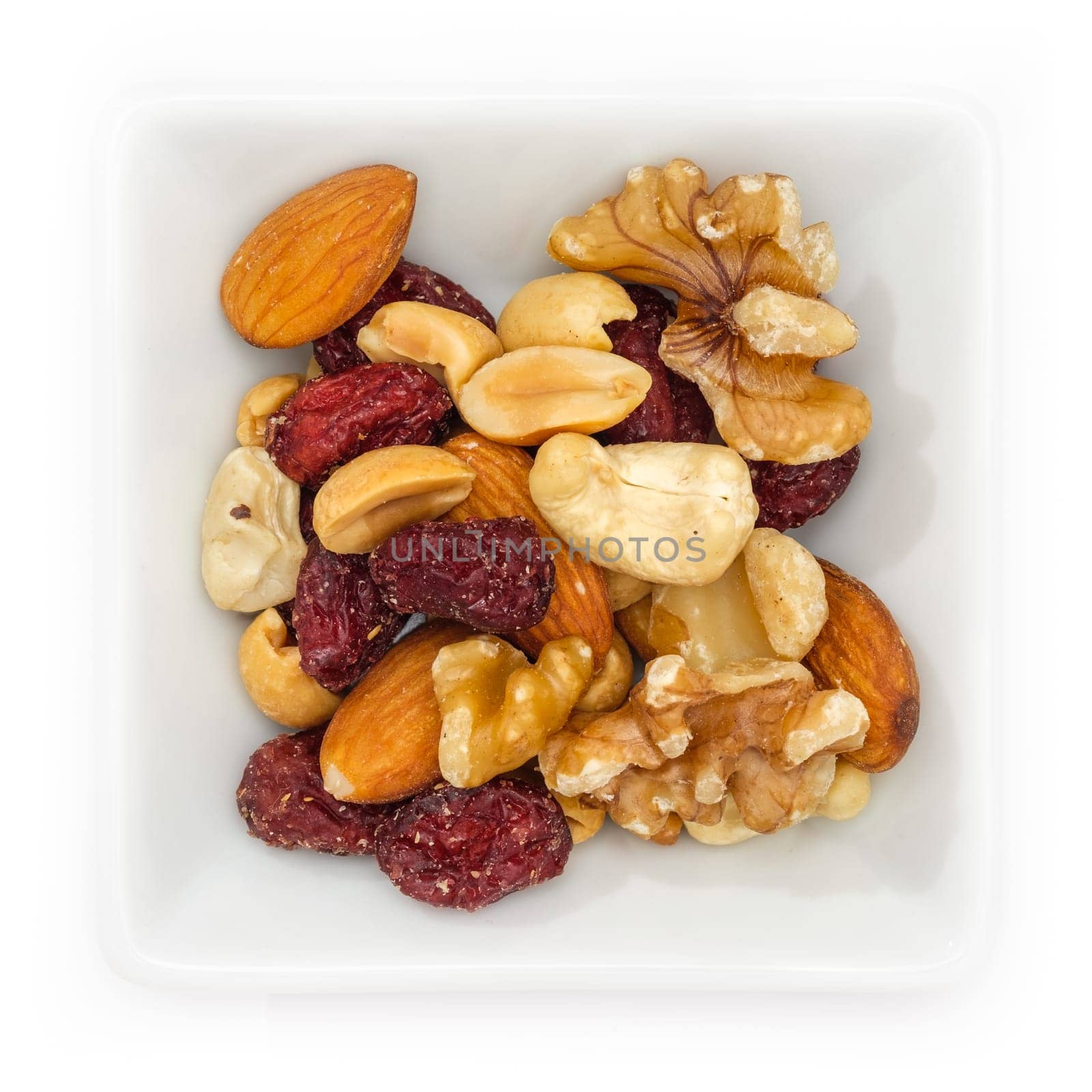 Gorp with cranberries in a white bowl in top view