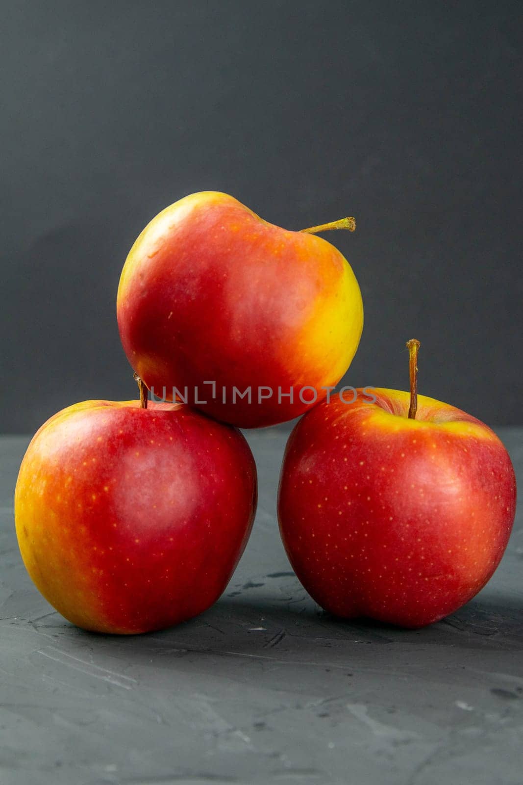 Apples on black stone table background. Front views