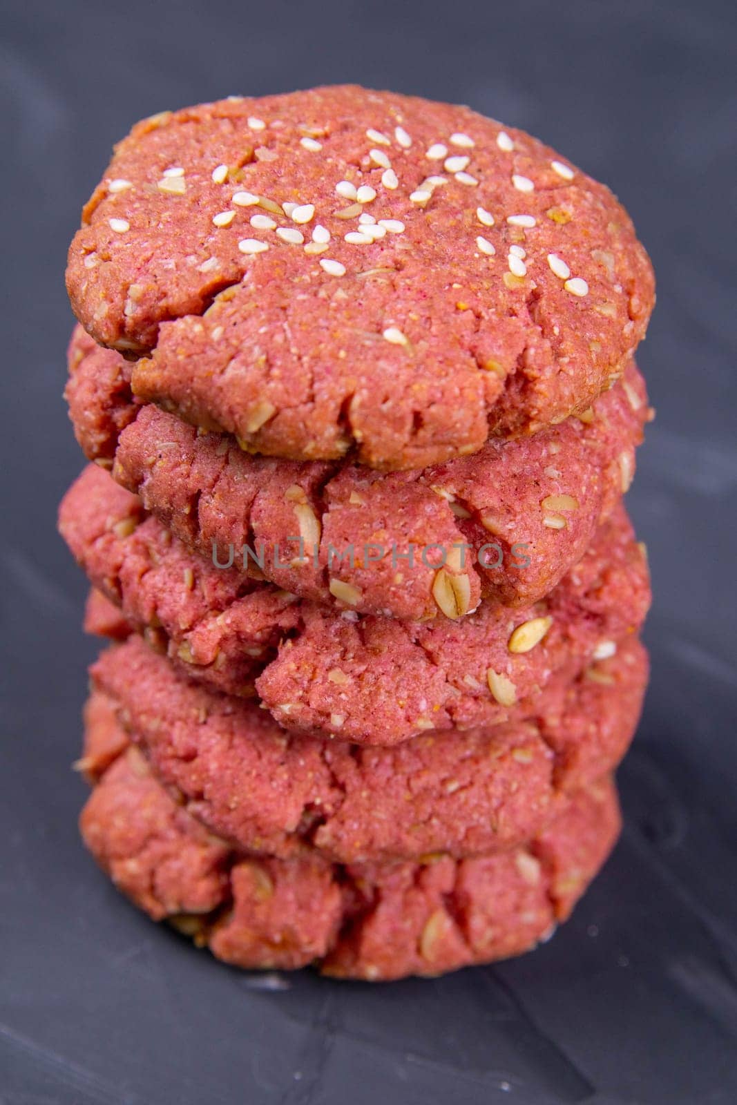 Oatmeal and beet cookies, on a on black wooden table. Food, holiday, cooking, baking background. Concept of home and healthy eating. Front views