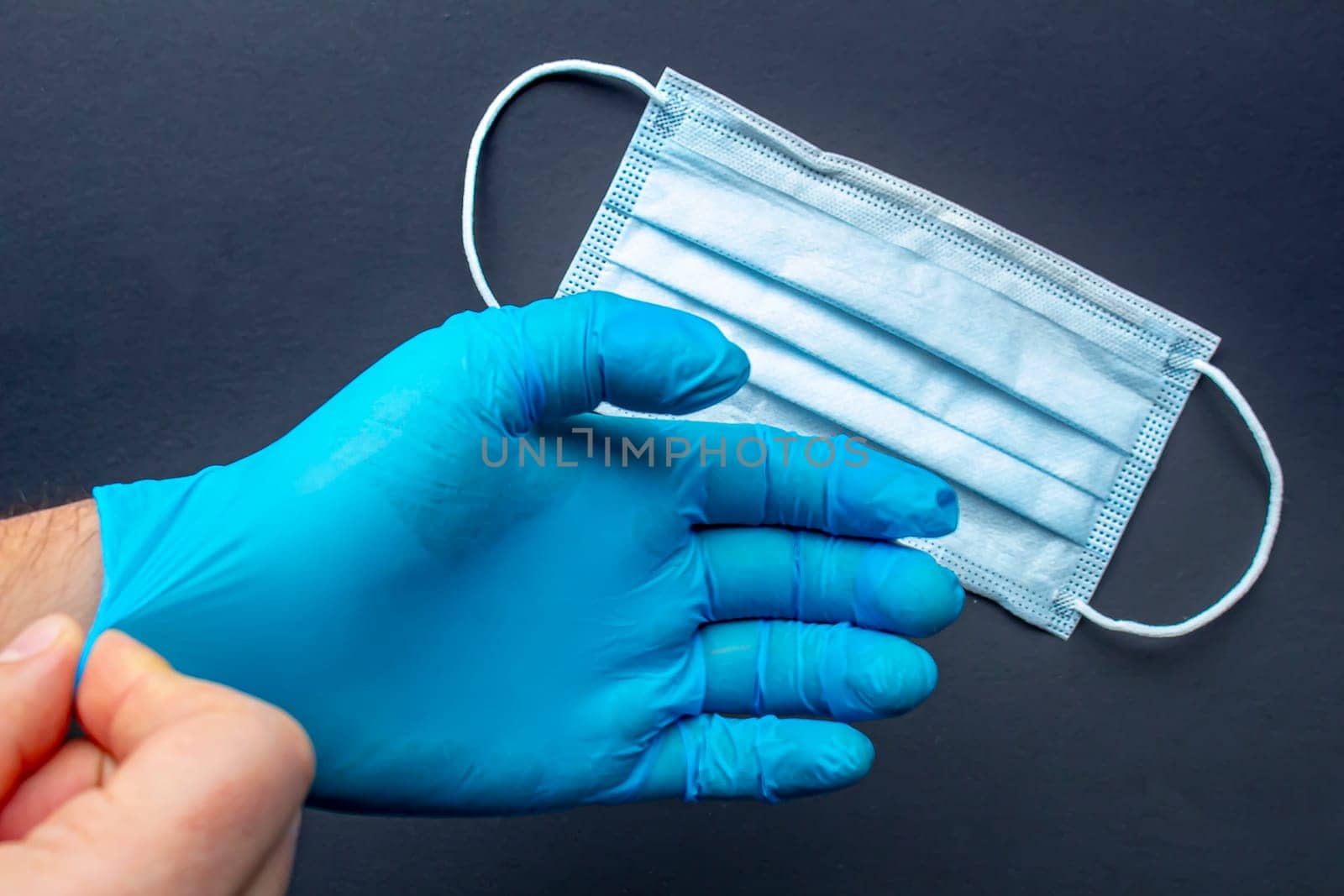 A medical first responder wearing gloves and face mask