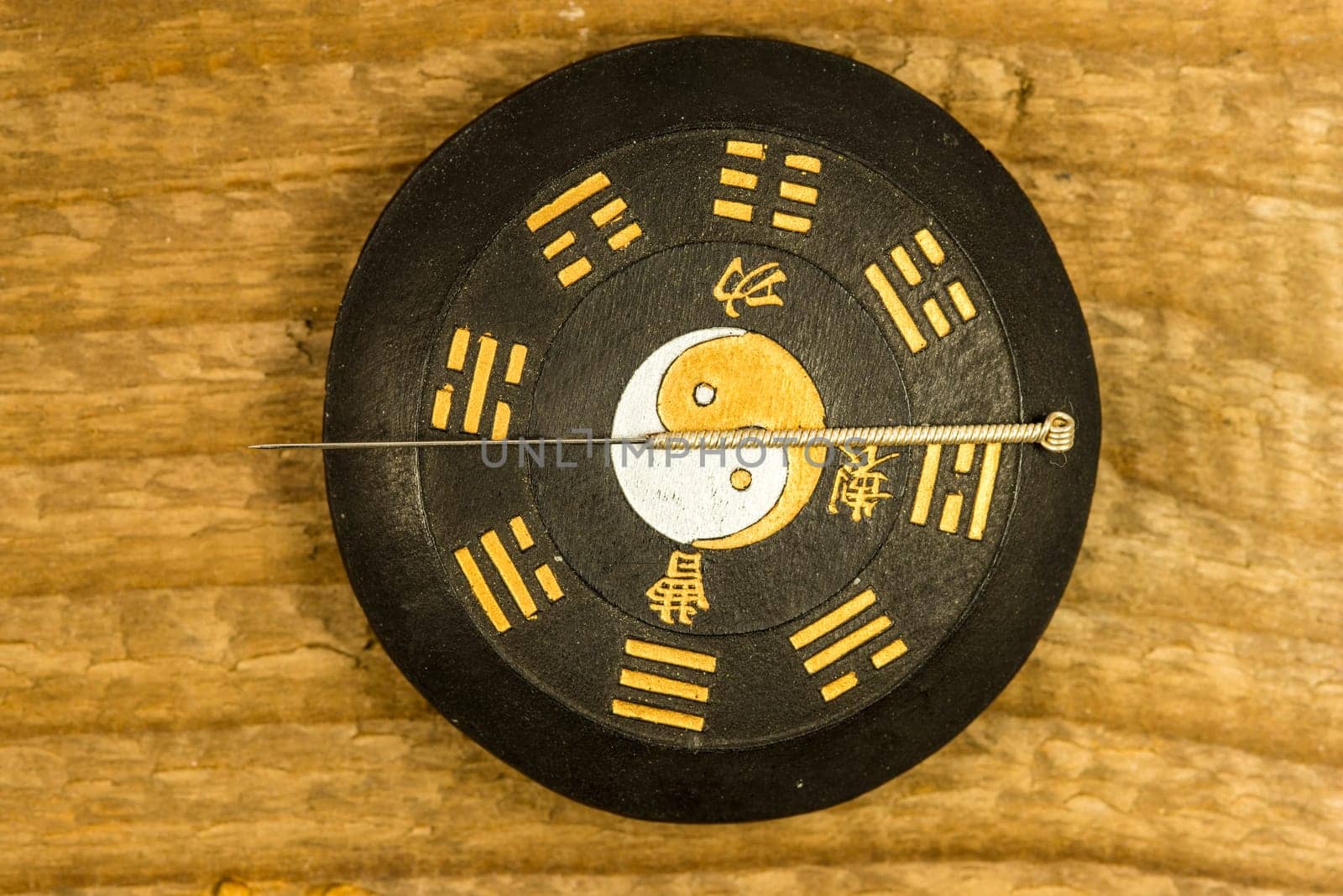 acupuncture needle on Chinese Taoism symbol