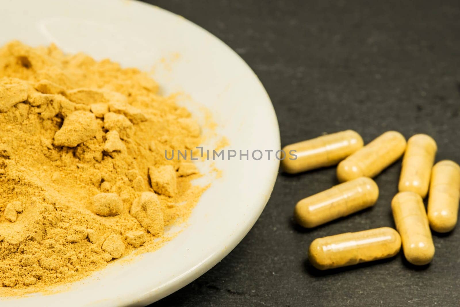 Maca, powder and capsules in a closeup