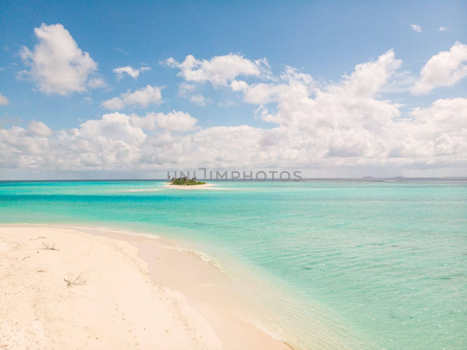 Picture perfect beach and turquoise lagoon on small tropical island on Maldives.