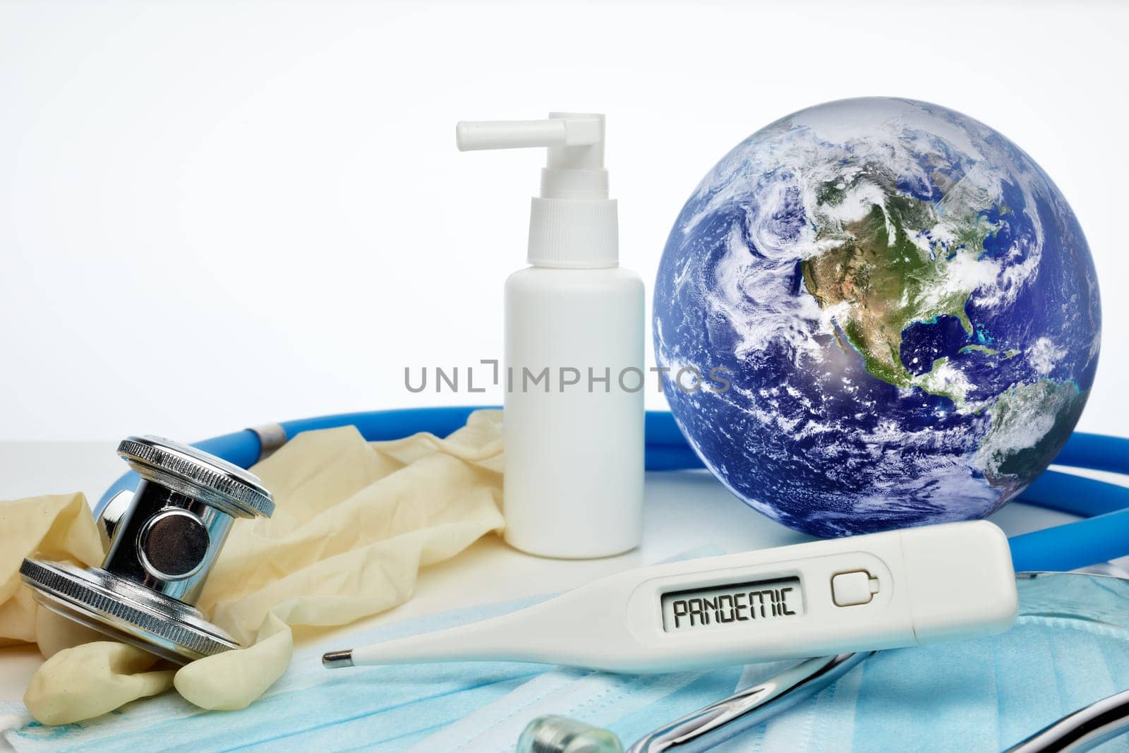 COVID-19. World globe with stethoscope, medical masks, sanitizer, thermometer on white background. Global quarantine, infection prevention, coronavirus. Elements of this image furnished by NASA