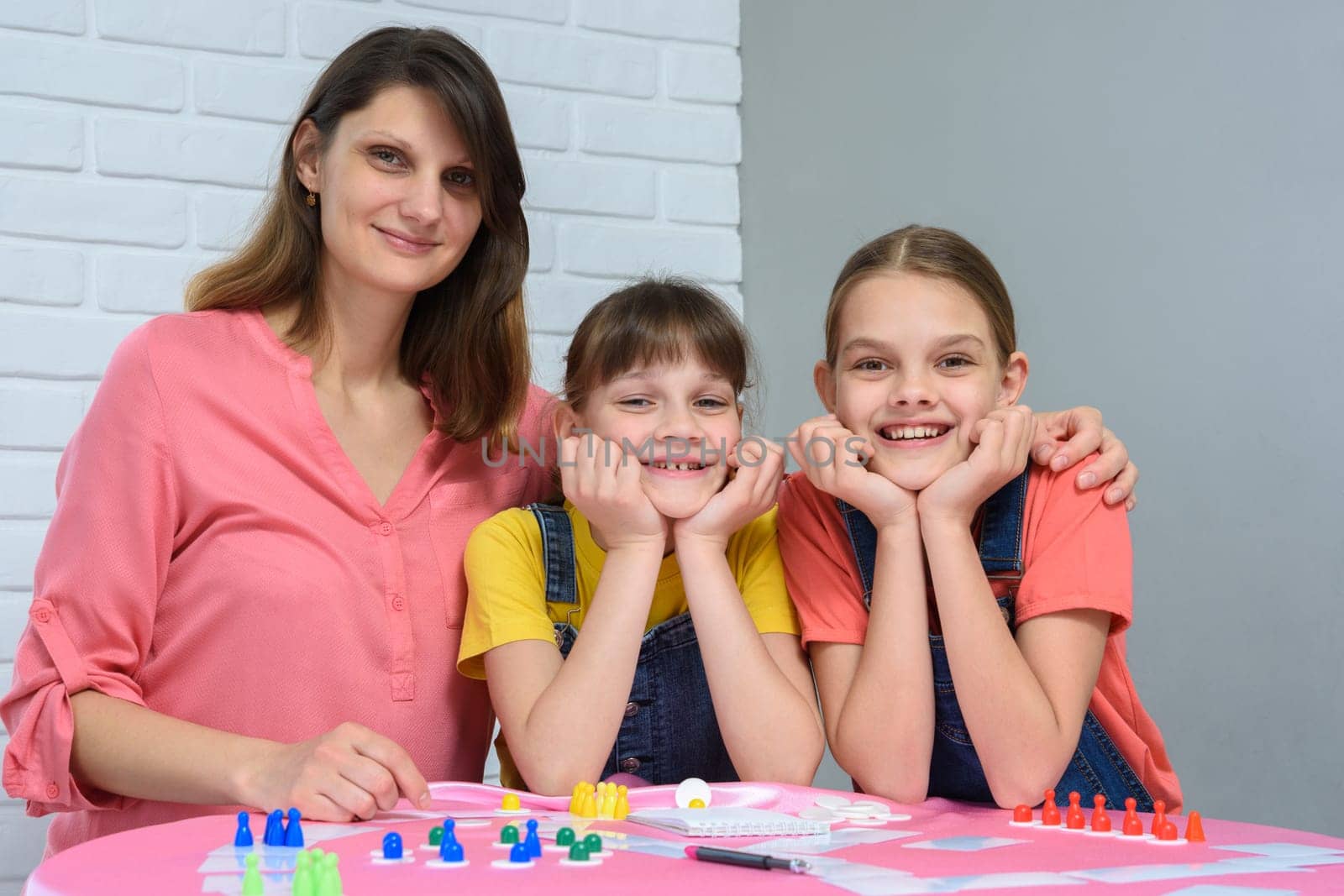 Portrait of a happy family playing board games at a table