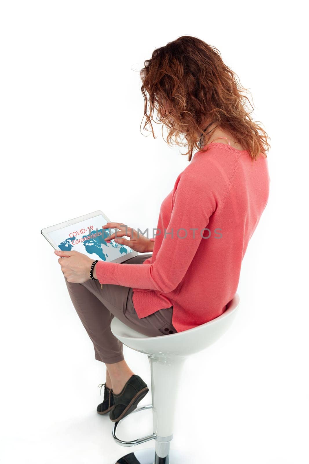 Portrait of cute joyful woman with trendy hairstyle wearing basic t-shirt talking on mobile phone isolated over white background.