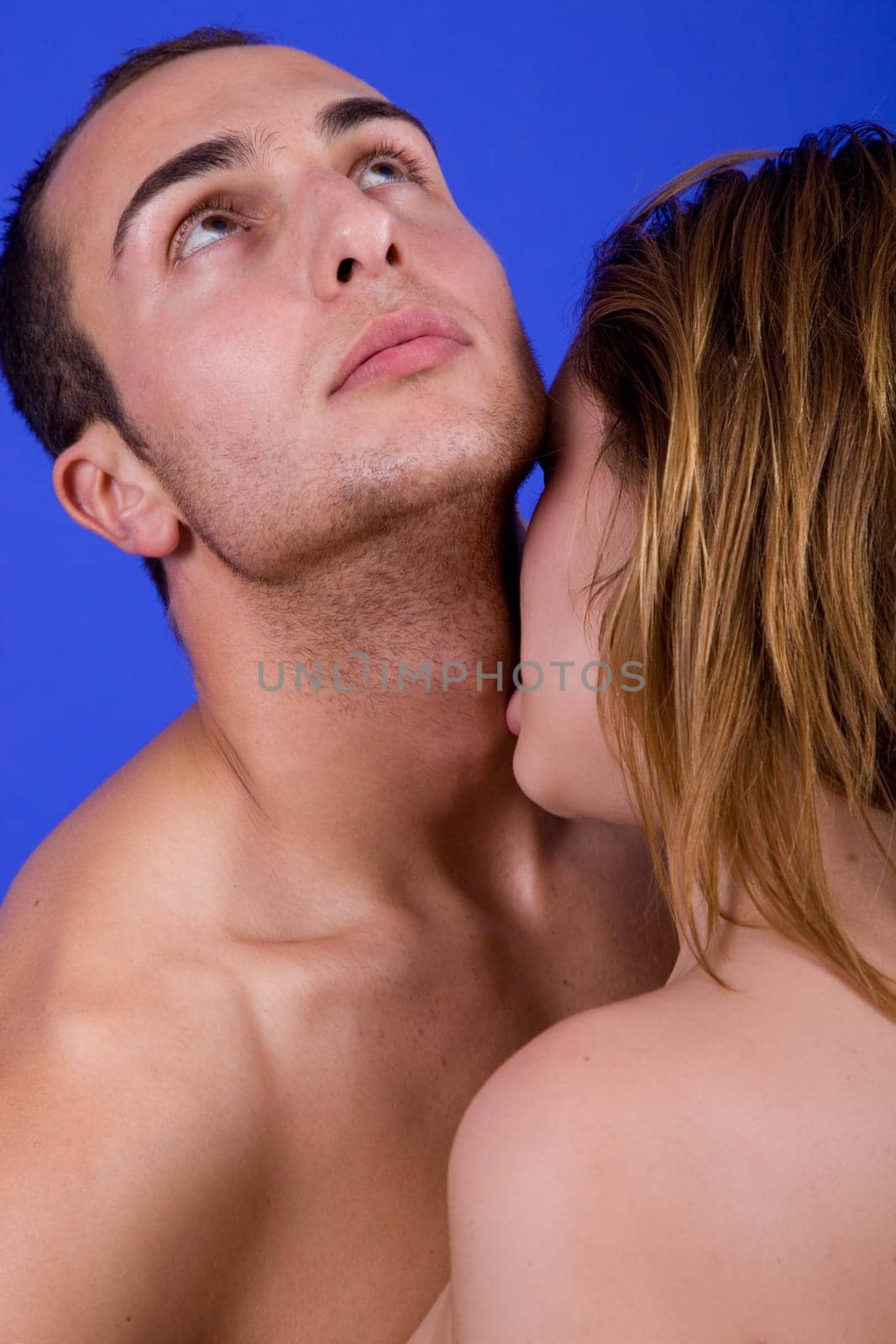 young couple together portrait on blue background