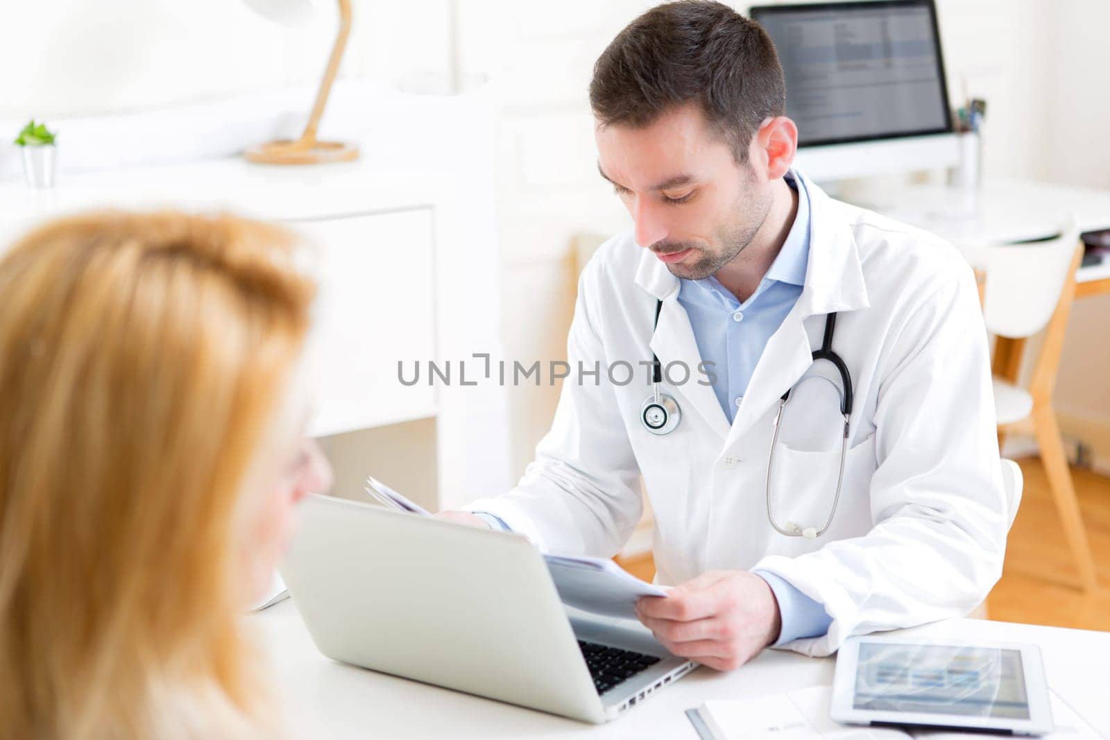 View of a Young attractive doctor listening his patient
