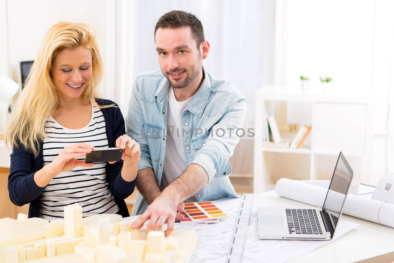 View of Two attractives architect working at the office