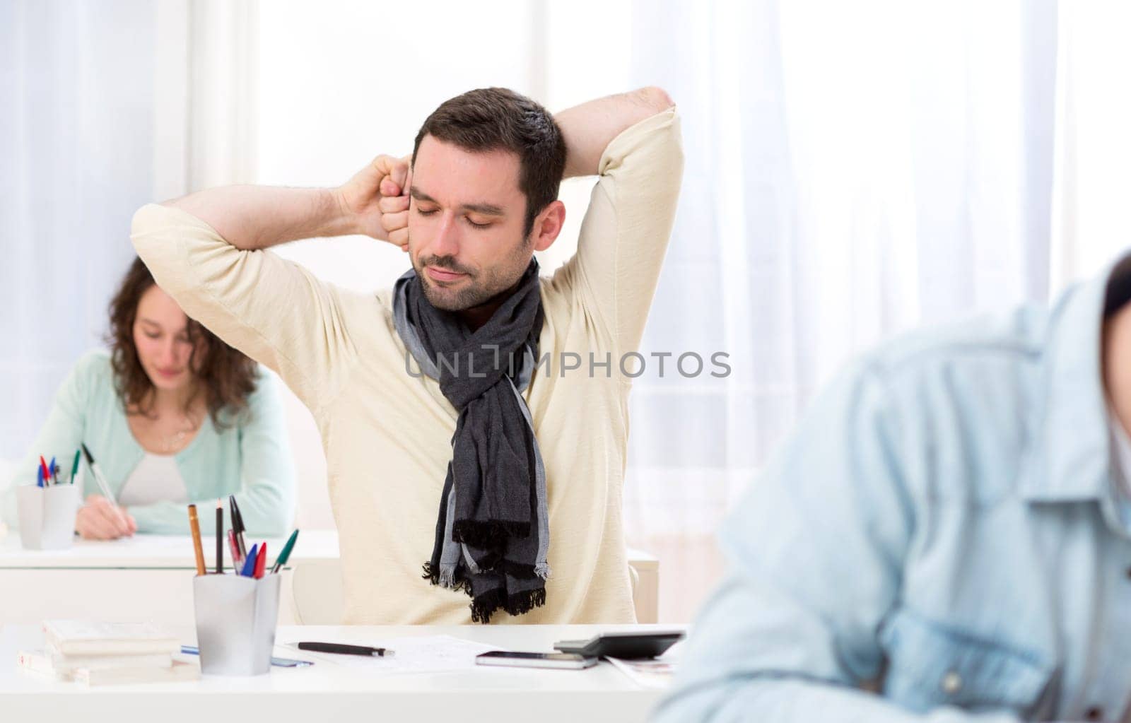 View of a Young attractive student stretching during classes