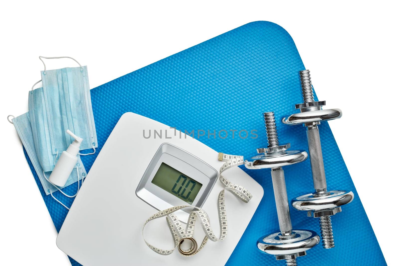 Sport equipment, scales, medical masks and sanitizer on white background. Top view, copy space. Fitness.  Isplation period. Weight and health control during quarantine. Concept of covid or coronavirus
