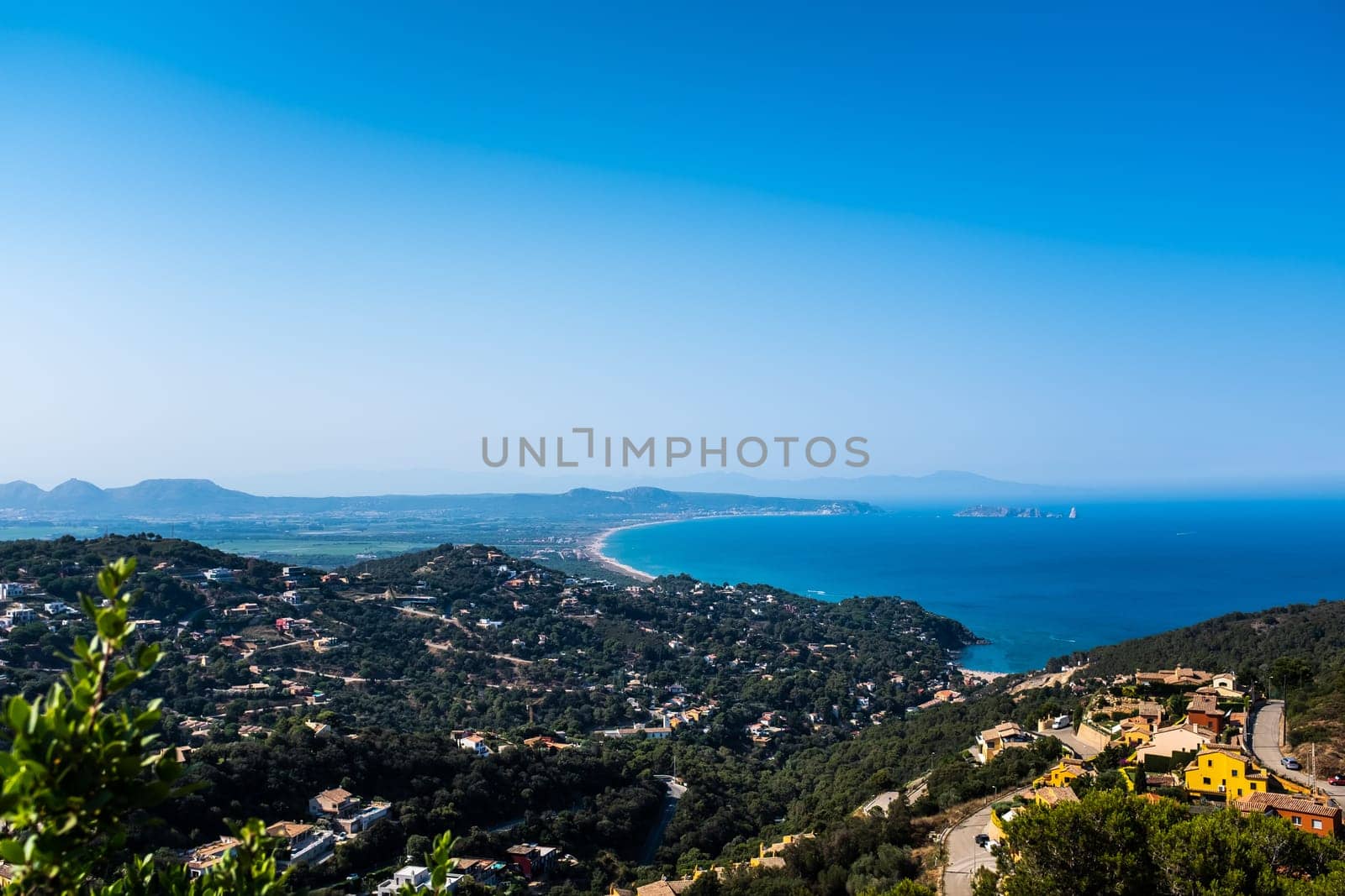 Wide-angle view of the bay close to L'Estartit and the Medes islands in Gerona Province, on the north-eastern coast of Spain. The Pyrenees mountain range is visible in the background.