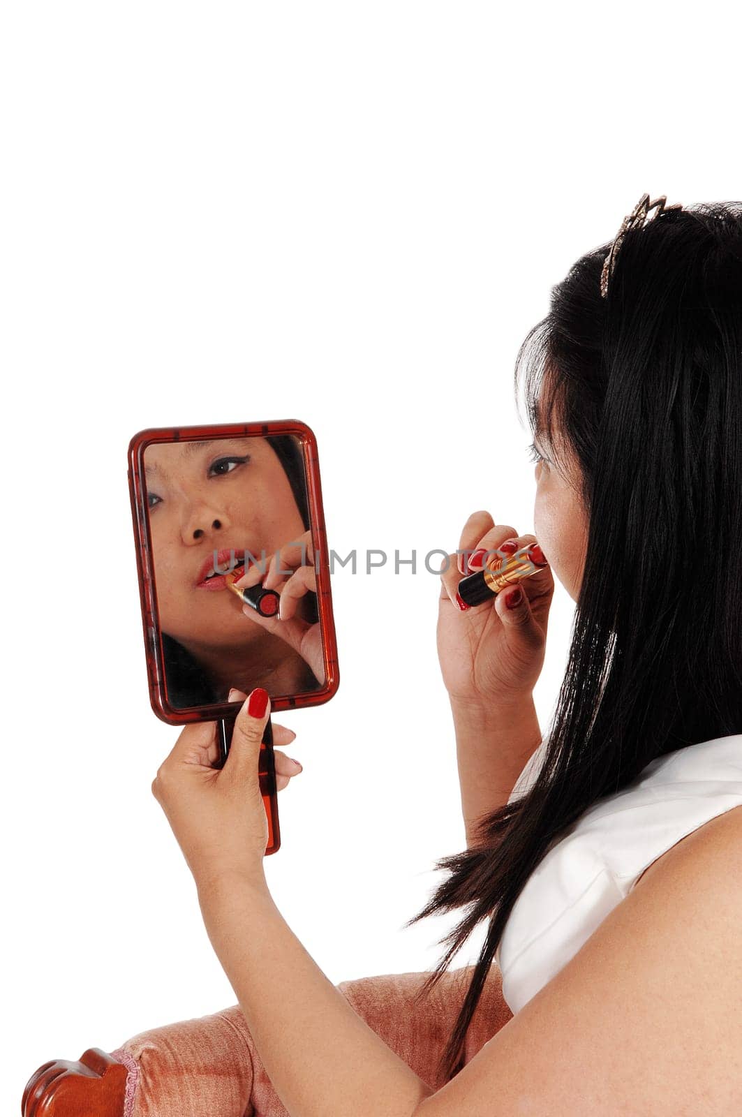 A Chinese woman, the face mirror fixing her lipstick, holding the .mirror, from the back, isolated for white background.