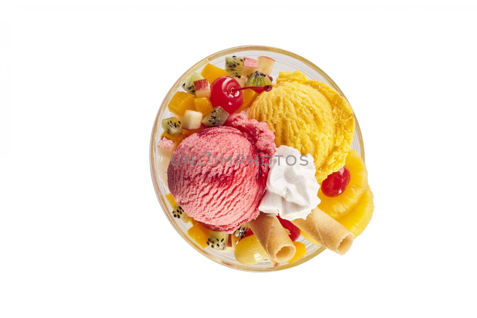 An above view of a tropical ice-cream sundae on a white background with copy space.