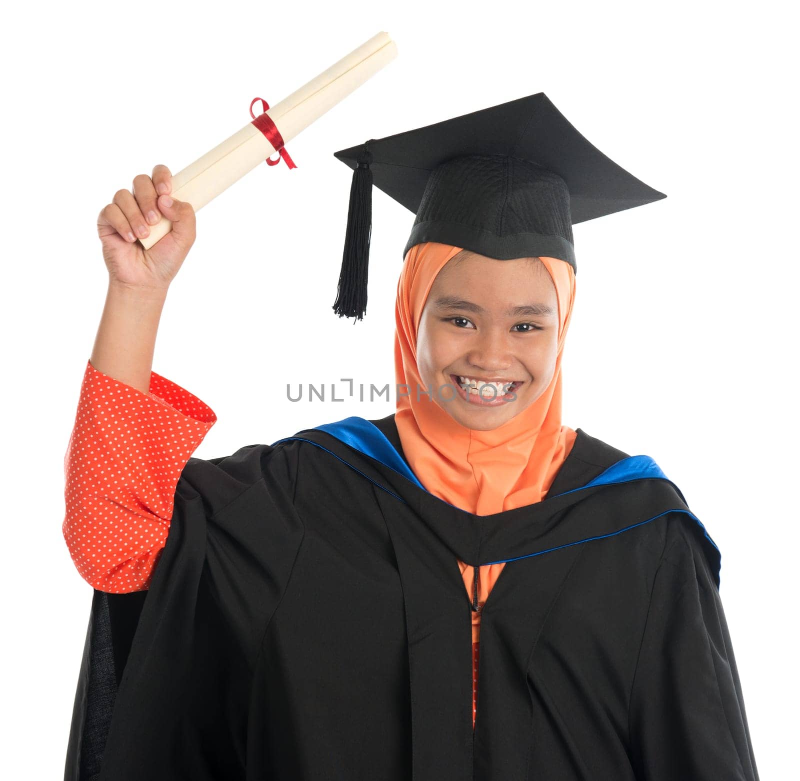 Female student in graduation gown, standing isolated white background.