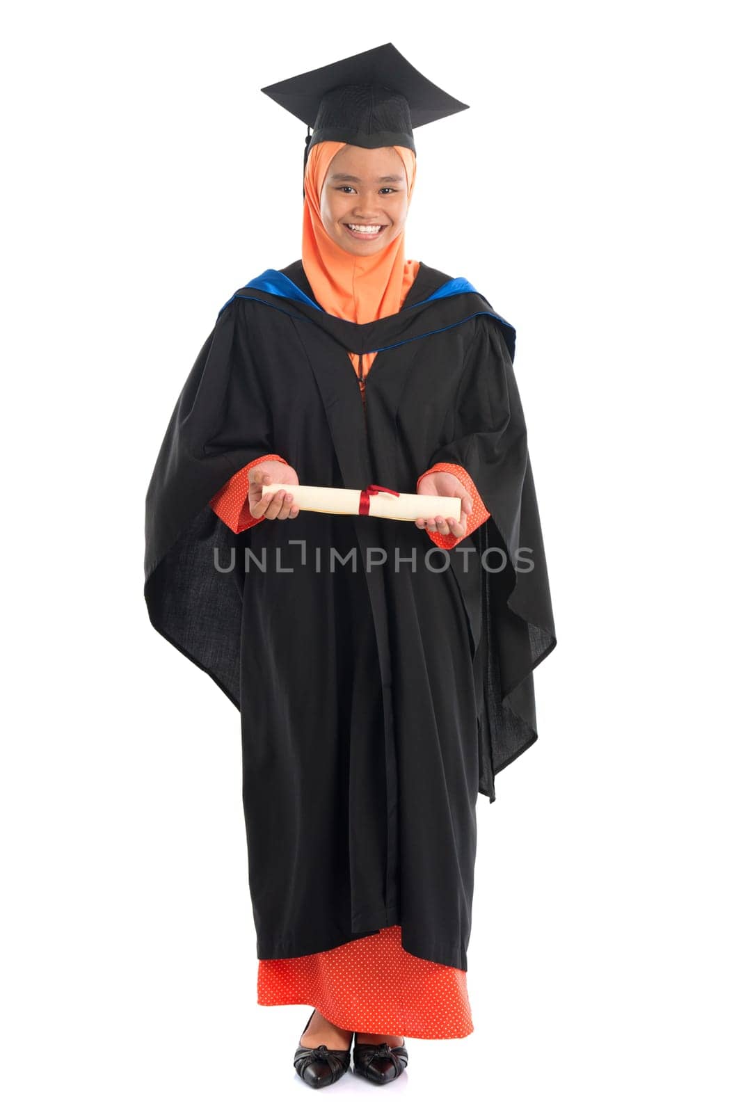 Full body female student in graduation gown, standing isolated white background.