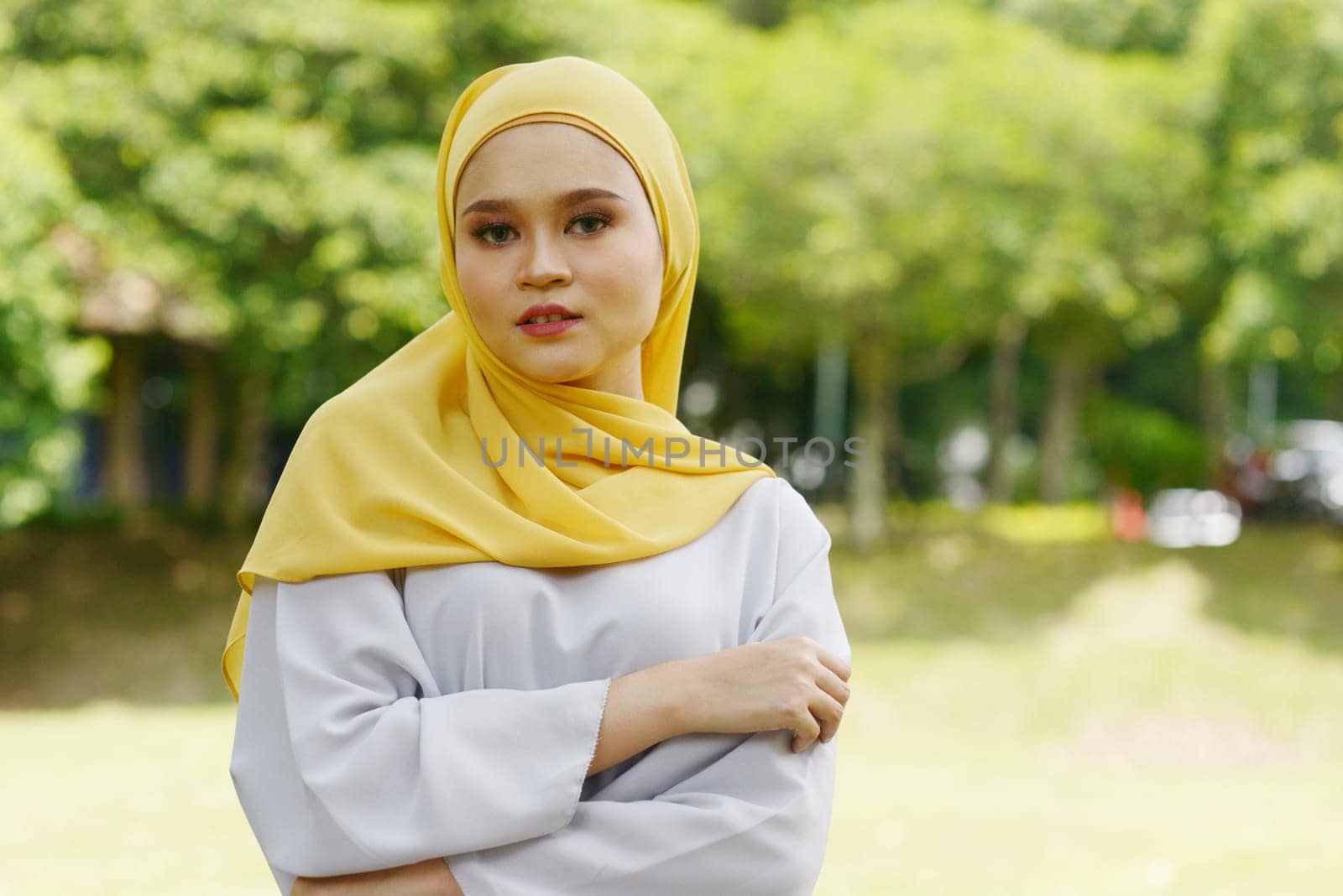 Portrait of cheerful Muslim girl in hijab, smiling at outdoor.