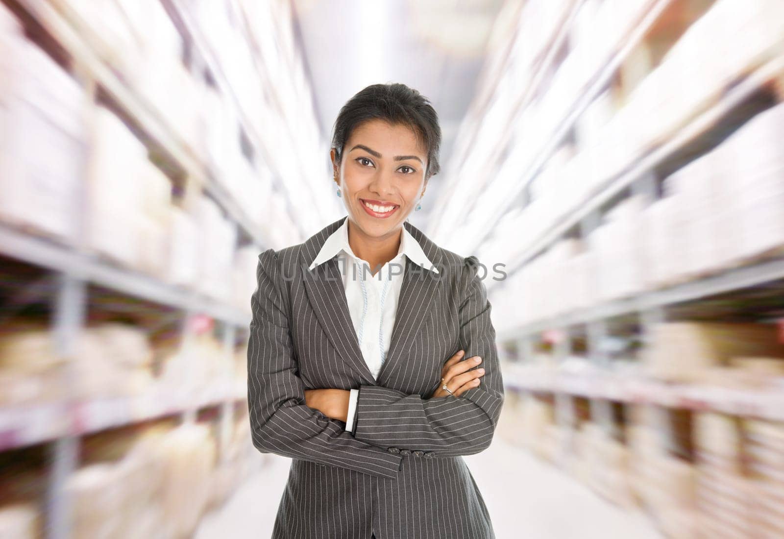 Business woman standing at warehouse.