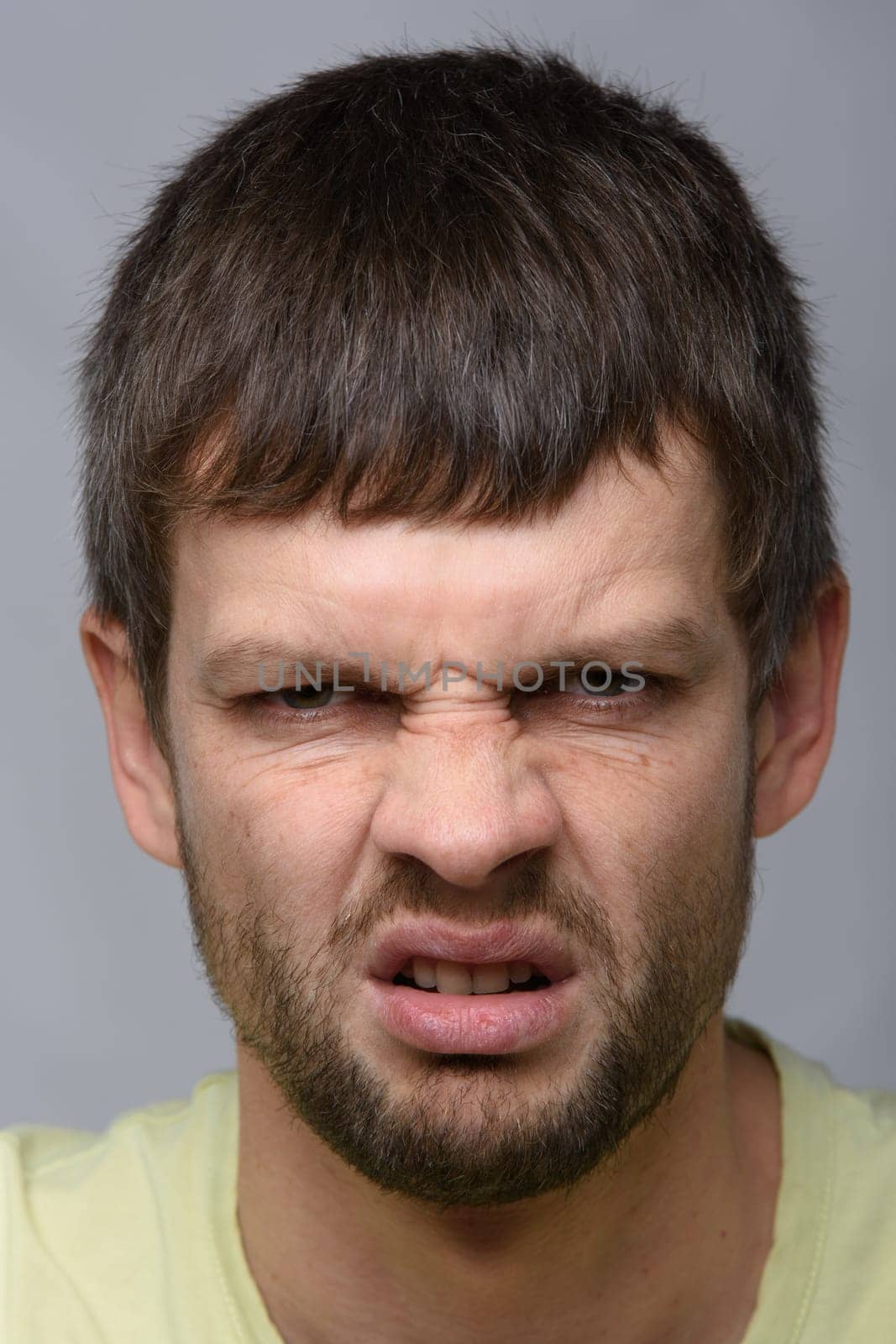 Closeup portrait of an evil man of European appearance