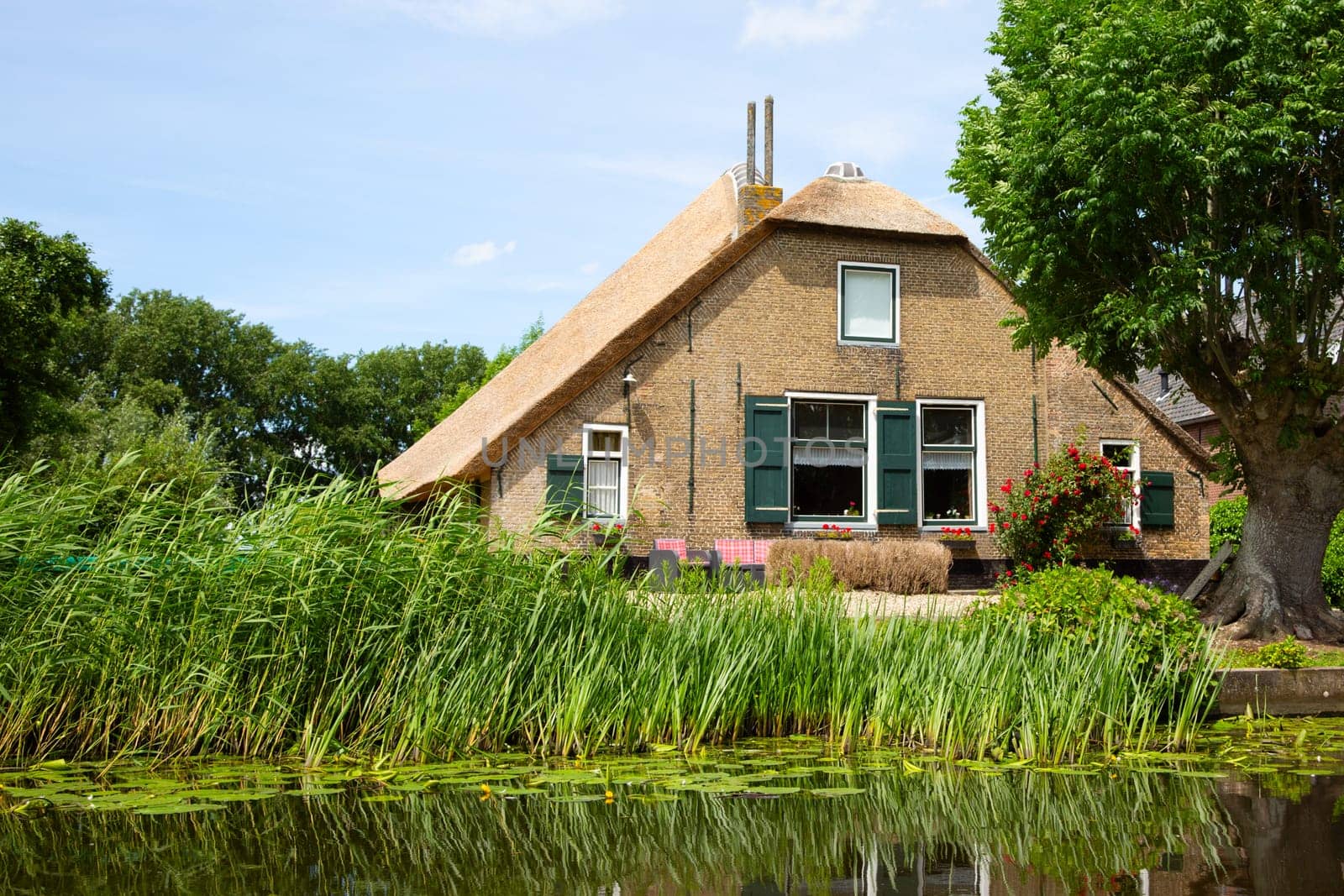 Traditional farm house on the river Graafstroom in the Netherlands..