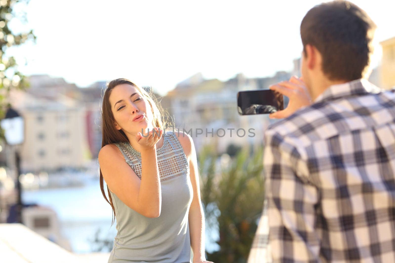 Tourists couple taking photos on phone on vacation