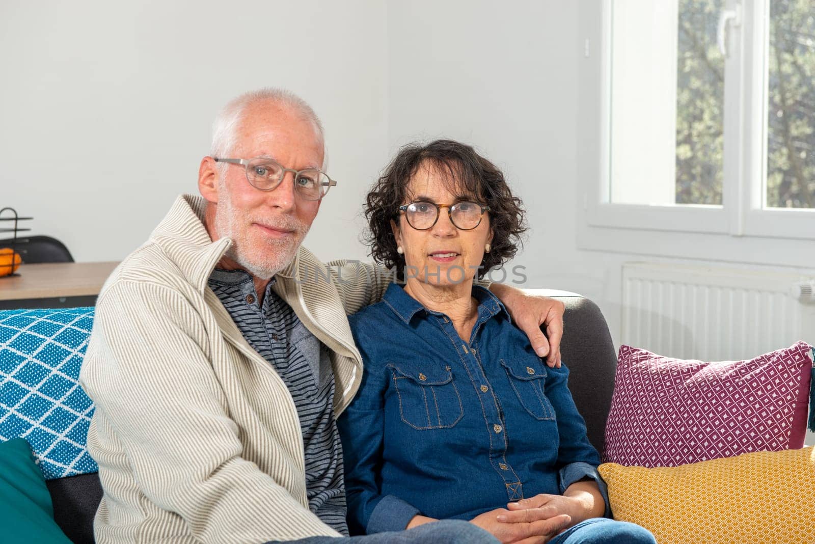 Senior couple relaxing on a sofa at home