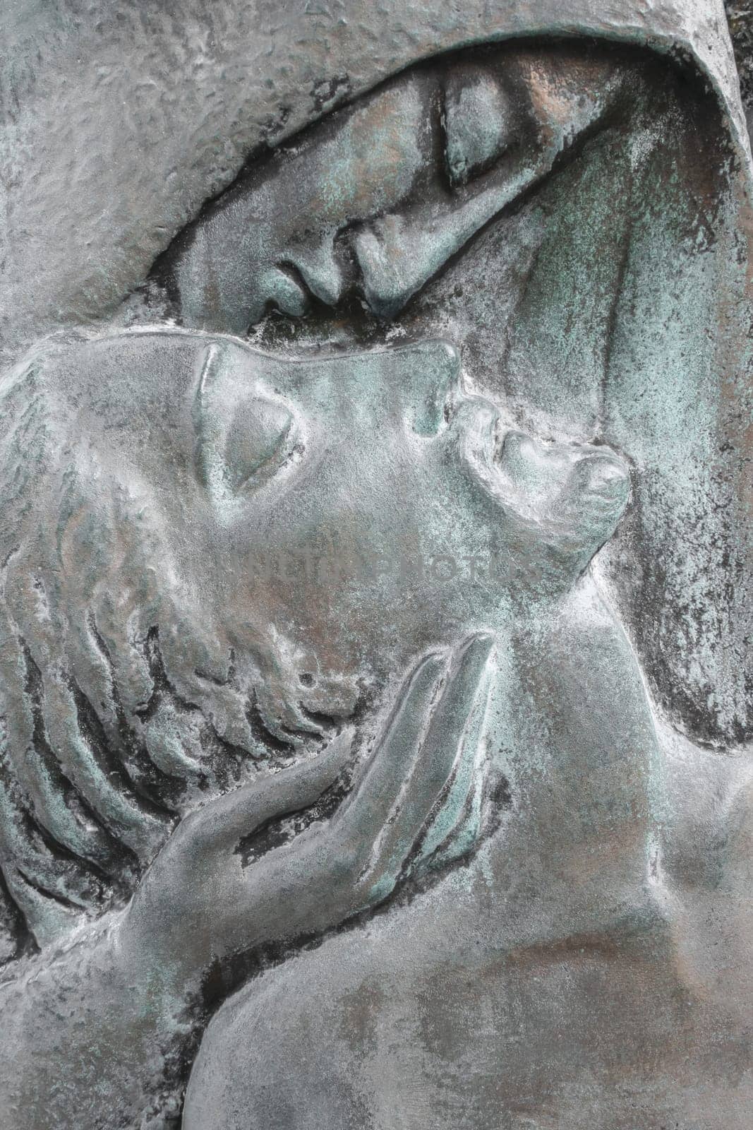Bronze relief of dead Jesus Christ down from the cross and the Virgin Mary. Easter and religion thematics.