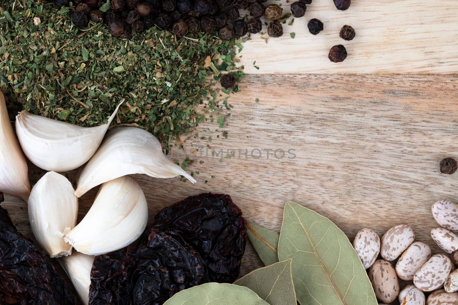 Garlic and other spices with dried pinto beans, flat lay with copy space