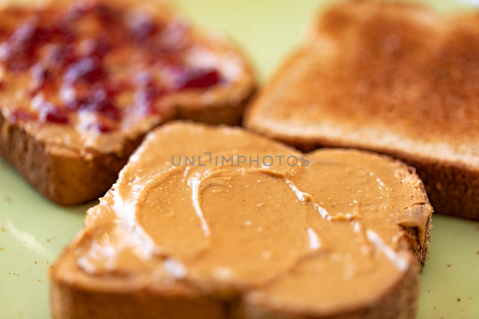Toasted whole wheat bread slices with peanut butter and jelly